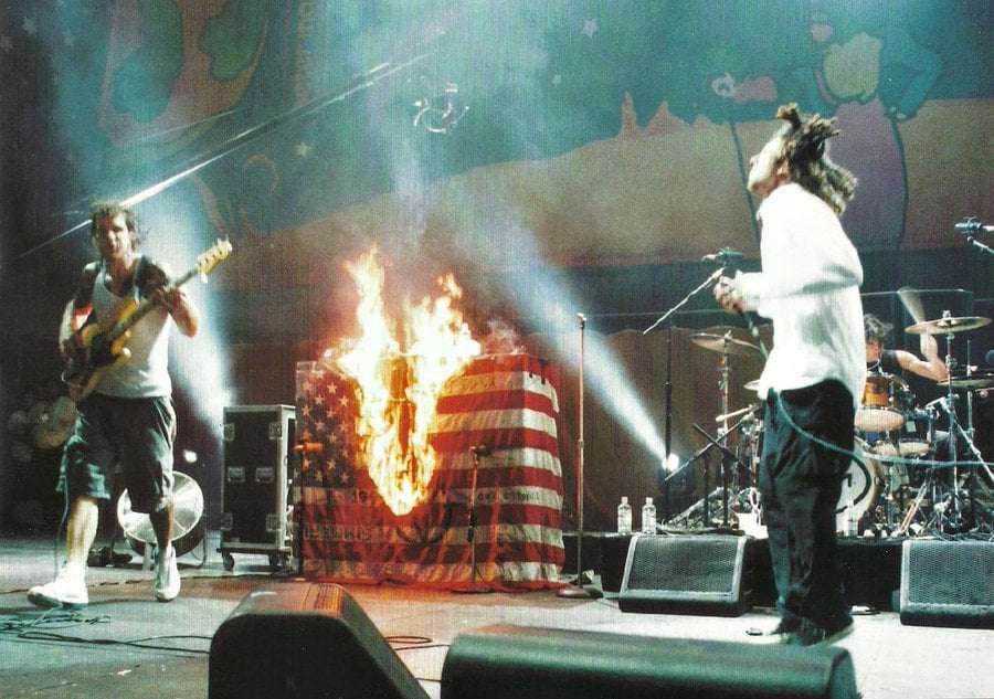 image showing Rage against the machine burning the American flag Woodstock 99