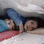 image for young girl covering her brother's head while stuck under the rubble after the earthquake
