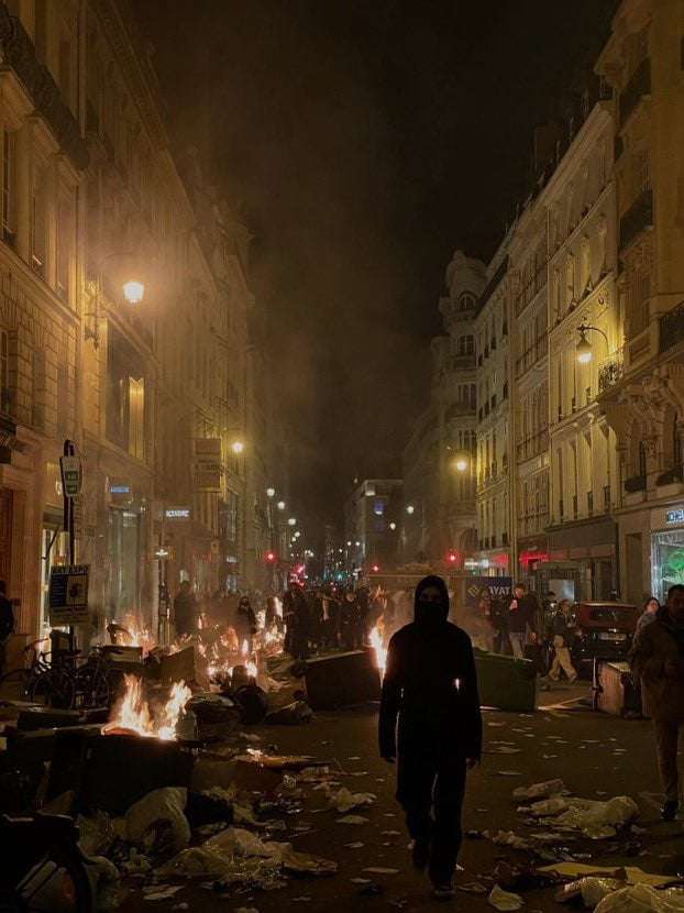 image showing Parisians rioting against pension reform.