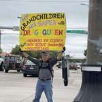 image for A protester at a busy intersection in Texas.