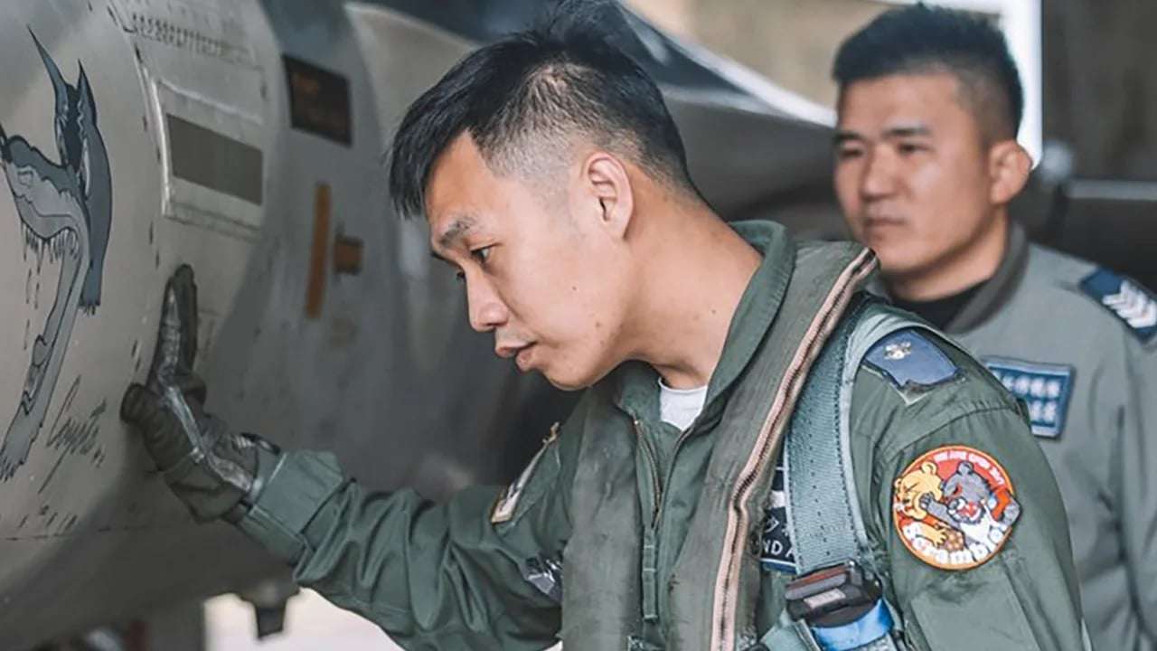 image showing Taiwanese pilot wears a badge showing a Taiwanese black bear punching Winnie the Pooh
