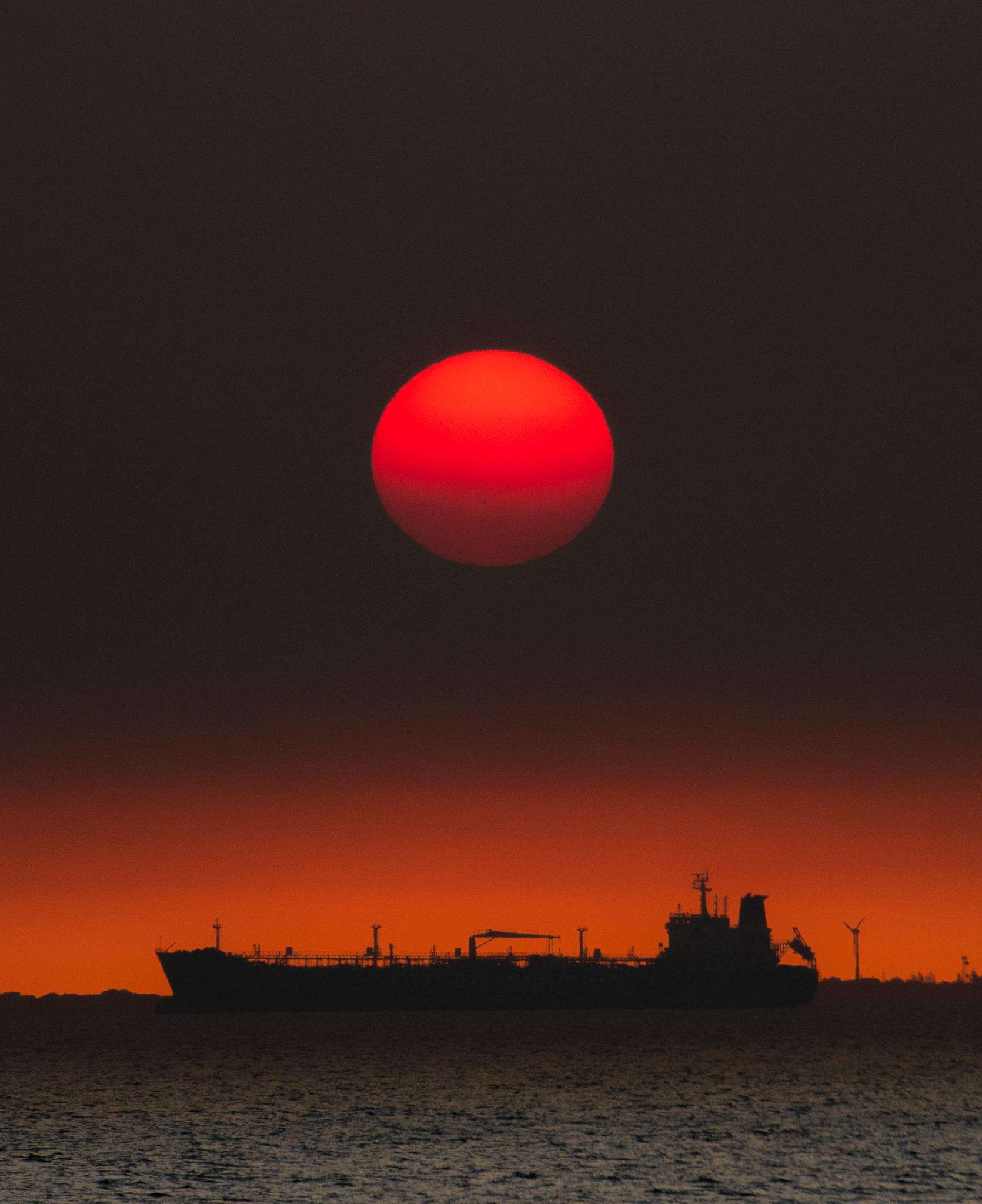 image showing ITAP of the sun setting over a ship