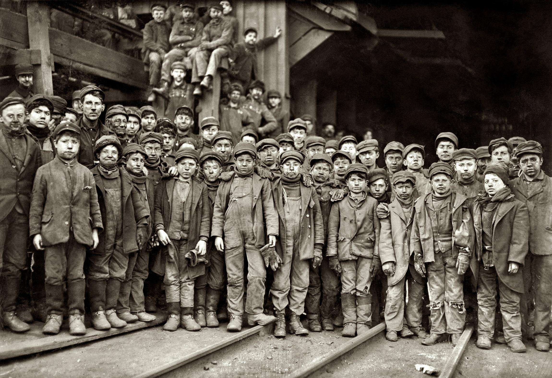 image showing "Breaker boys," most 8–12, who worked 60-hour weeks breaking coal when child labor was permitted