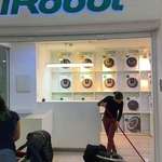 image for An employee cleaning the floor of a Roomba store