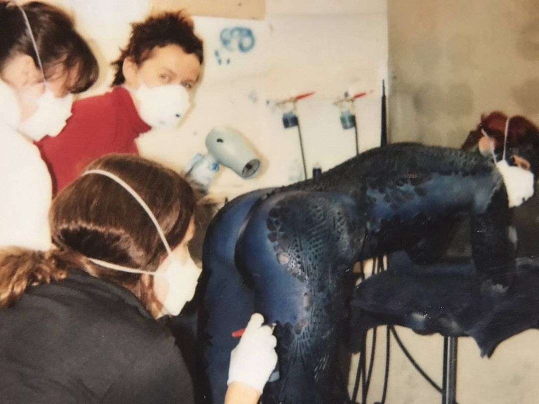 image showing Applying makeup to Rebecca Romijn on the set of «X-Men», 2000