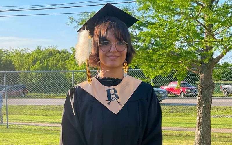 image for Oklahoma school officials tried to rip a Native American student's sacred feather off her cap at graduation, lawsuit alleges