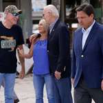 image for Ron DeSantis walks past Biden, seething