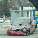 image for "Elon Musk Dickhead" written on a destroyed by Russians car in Ukraine