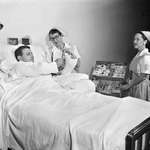 image for Candy Stripers selling cigarettes to a hospital patient. Photo - Thomas Robinson