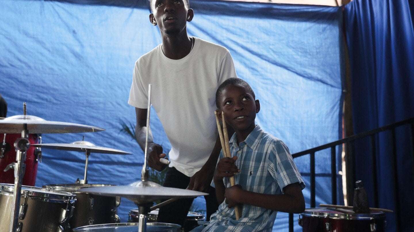 image for Haitian students play drums and strum guitars to escape hunger and gang violence