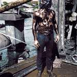 image for A diver photographed after ascending from the oily interior of sunken battleship USS Arizona,1941.