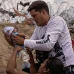image for Yusniel, migrant from Cuba, holds his 10 day old son Yireht after crossing Rio Grande to get to USA.