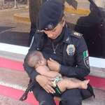 image for A police woman breastfeeds a baby from a misplaced family during Acapulco rescue efforts.