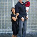image for Nathan Jones (6’11”), former Pro-WWE fighter, with his wife Fawn Tran and their child.