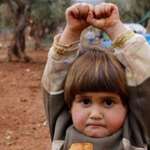 image for Syrian child mistakes camera for gun
