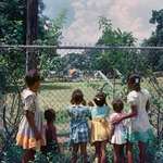 image for Black children watching as white children play in a only whites park, 1955