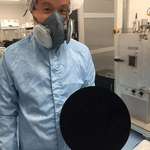 image for Scientist holding a basketball covered with Vantablack, the world's blackest substance no reflection