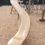 image for A picture of a new type of slide being implemented in parks where you slide down legs over the edge.