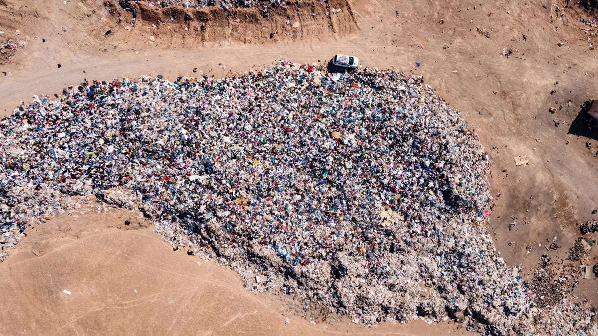 image for A Mountain of Used Clothes Appeared in Chile’s Desert. Then It Went Up in Flames