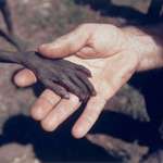 image for In 1980, Mike Wells photographed a missionary comforting a starving Ugandan boy during famine.