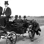 image for A beggar running alongside King George V's coach begging for alms, 1920