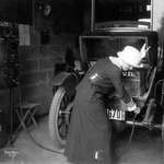 image for A 1912 photo shows a woman plugging in her electric car