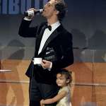 image for Picture of McConaughey accepting an award with a beer in one had and daughter by his side
