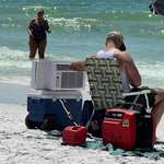 image for A man at the beach with an air conditioning unit