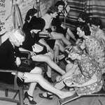 image for Women having stockings painted on instead of buying them during war time, 1941.