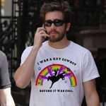 image for Jake Gyllenhaal wearing 'I was a gay cowboy before it was cool' T-shirt.