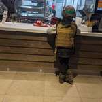 image for Kharkiv, Ukraine. Kid in a bulletproof vest waiting for his KFC order.