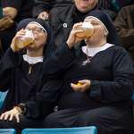 image for Two women wearing nun outfits drink beer while watching the Tim Hortons Brier curling championship