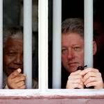 image for Nelson Mandela in his former prison cell with Bill Clinton (1998).