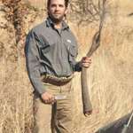 image for Donald Trump Jr. holding the tail of an elephant he just cut off.
