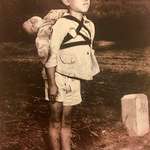 image for A Japanese boy waiting in line at the crematorium with his dead brother on his back, Nagasaki, 1945.