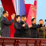 image for Kim Jong Un, his daughter, and officials clapping together at the grand opening of new housing block
