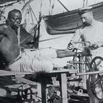 image for A British blacksmith removing the leg irons off a slave in 1907