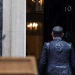 image for Rishi Sunak makes his way back into 10 Downing Street after announcing an election in the heavy rain