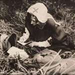 image for A red cross nurse writing down last words of mortally wounded soldier, taken around 1917
