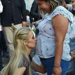image for Paris Hilton kissing a woman's belly because she mistakenly thought she was pregnant