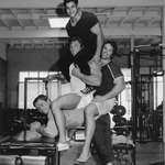 image for Arnold Schwarzenegger being mounted by 3 men in the gym, 1970s. F. Zane, Franco Columbu and unsure
