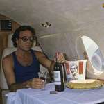 image for Julio Iglesias on his private jet with a bottle of wine and a bucket of KFC