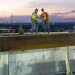 image for Canadian and US Ironworkers shake hands as the Gordie Howe Bridge becomes an international crossing