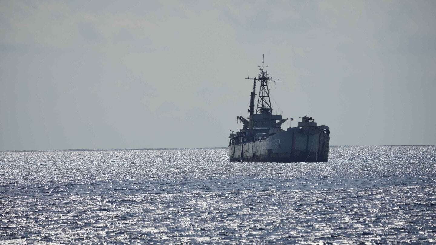 image for Philippine officials say Chinese forces seized 2 navy boats in disputed shoal, injuring sailors