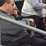 image for Ex governor of New Jersey Chris Christie, pouring a bag of M&M’s into an even bigger bag of M&M’s.