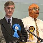 image for Jacob Rees-Mogg standing next to man wearing a baked beans balaclava after losing the election