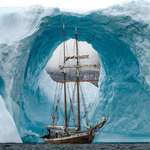 image for A 108ft long two-masted sailing ship in front of this massive blue iceberg, Greenland 2023