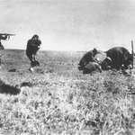 image for A woman holds a child in her arms as Nazis prepare to murder them and their neighbours, 1942