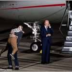 image for Evan Gershkovich lifts his mother, Ella Milman, while Joe Biden looks on, on the tarmac at JBA