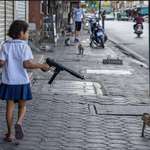 image for On her way home, a younger girl uses an airsoft machine gun to avoid being attacked by monkeys.